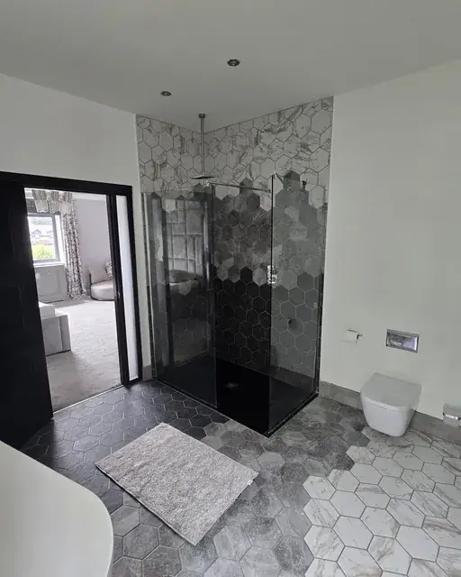 Walk-in shower finished in hexagon marble-effect tile